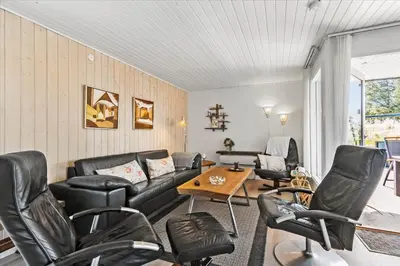 a living room with black leather furniture and a table at BL411-Pandrup-Hunetorp-Klitvej-223 in Pandrup
