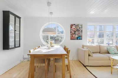 a living room with a table and a couch at BL1527-Blokhus-Svinget-5 in Blokhus