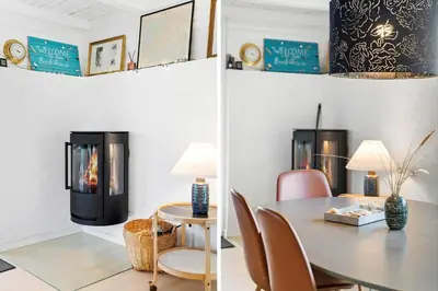 a living room with a fireplace and a table and chairs at BL1314-Pandrup-Nordvej-11 in Pandrup