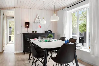 a dining room with a table and chairs at BL1286-Saltum-Lyngsletten-4 in Saltum