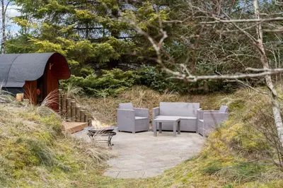 a patio with two chairs and a table and a bench at BL1286-Saltum-Lyngsletten-4 in Saltum
