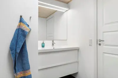 a bathroom with a sink and a mirror at BL1286-Saltum-Lyngsletten-4 in Saltum