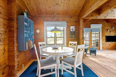 a dining room with a white table and chairs at BL969-Blokhus-Bregnehojvej-16 in Blokhus