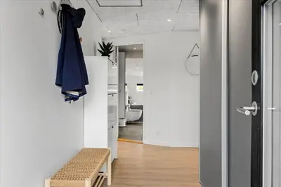 a room with a hallway with a robe hanging on a wall at BL1315-Saltum-Kordalsvej-43 in Saltum