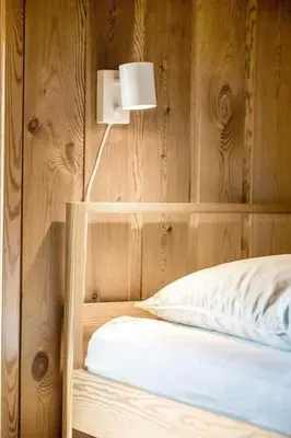 a bedroom with a bed with a wooden wall at BL1616-Blokhus-Moreavej-18 in Blokhus