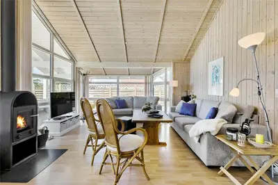a living room with a couch and a fireplace at BL791-Blokhus-Paa-Bakken-3 in Blokhus