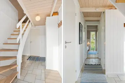 a hallway of a home with white walls and stairs at BL830-Pandrup-Bardehvalen-3 in Pandrup