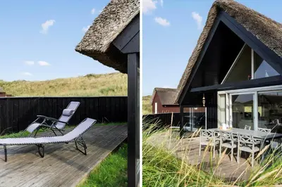 a house with a thatched roof and a deck at BL830-Pandrup-Bardehvalen-3 in Pandrup