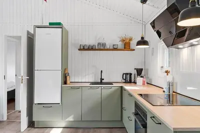 a kitchen with a white refrigerator and a sink at BL1654-Saltum-Ornebjergvej-11 in Saltum