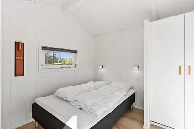 a bed in a white room with a window at BL1654-Saltum-Ornebjergvej-11 in Saltum