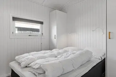 a large bed in a white room with a window at BL1654-Saltum-Ornebjergvej-11 in Saltum