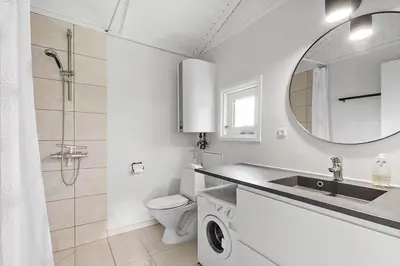 a bathroom with a sink and a toilet and a mirror at BL1654-Saltum-Ornebjergvej-11 in Saltum