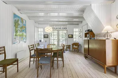 a dining room with a table and chairs at BL1384-Blokhus-Kragebak-7 in Blokhus