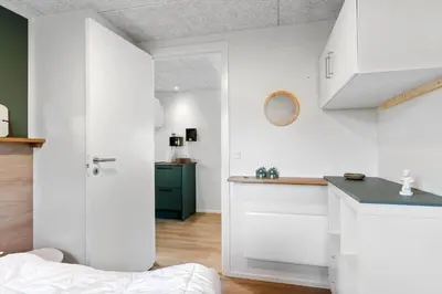 a white kitchen with a sink and a counter at BL1377-Blokhus-Valmuemarken-37 in Blokhus