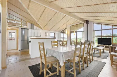 a kitchen and dining room with a table and chairs at BL451-Saltum-Trehoje-14 in Saltum