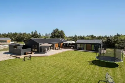 a house with a large yard with a playground at BL1257-Saltum-Vesterhavs-Sletten-35 in Saltum