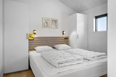 a white bedroom with two beds with white blankets at BL1257-Saltum-Vesterhavs-Sletten-35 in Saltum