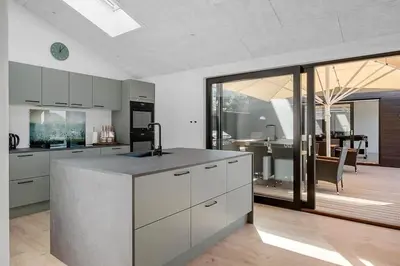 a kitchen with a counter and a dining room at BL1257-Saltum-Vesterhavs-Sletten-35 in Saltum