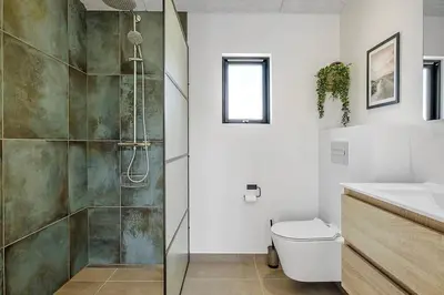 a bathroom with a shower and a toilet and a sink at BL1257-Saltum-Vesterhavs-Sletten-35 in Saltum