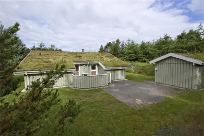 a house with a grass roof with a garage at BL178-Saltum-Ornebjergvej-16 in Saltum