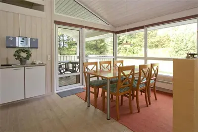 a kitchen and dining room with a table and chairs at BL178-Saltum-Ornebjergvej-16 in Saltum