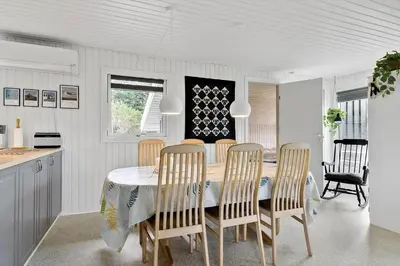 a kitchen and dining room with a table and chairs at BL1029-Pandrup-Rodhus-Skolevej-9 in Pandrup