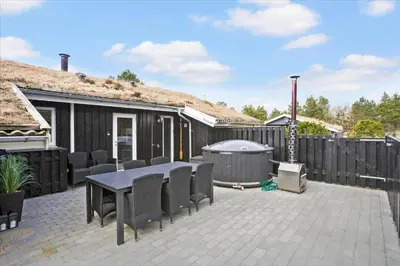 a patio with a table and chairs and a grill at BL1029-Pandrup-Rodhus-Skolevej-9 in Pandrup