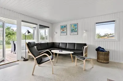 a living room with a black couch and a table at BL1029-Pandrup-Rodhus-Skolevej-9 in Pandrup
