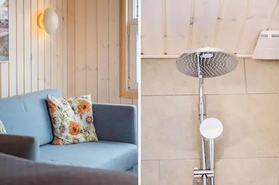 a room with a blue couch and a floor lamp at BL709-Blokhus-Kr-Thomsensvej-5 in Blokhus