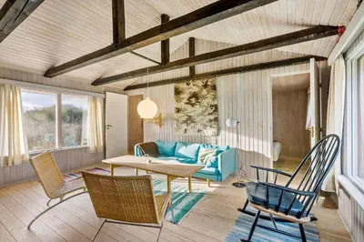 a living room with a blue couch and chairs at BL1697-Pandrup-Marsvinet-34 in Pandrup
