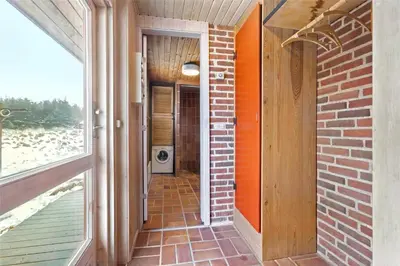 a hallway of a house with a brick wall at BL1697-Pandrup-Marsvinet-34 in Pandrup