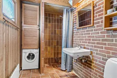 a bathroom with a washing machine and a sink at BL1697-Pandrup-Marsvinet-34 in Pandrup