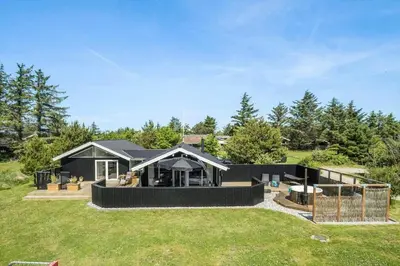 a home with a large yard with a house at BL1346-Blokhus-Septimusvej-19 in Blokhus