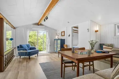 a living room with a table and a couch at BL958-Blokhus-Havorns-Alle-14 in Blokhus