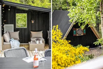 a patio with a table and chairs and a black shed at BL958-Blokhus-Havorns-Alle-14 in Blokhus
