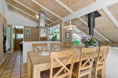 a kitchen and dining room with a wooden table and chairs at BL1636-Saltum-Saltum-Strandvej-140 in Saltum