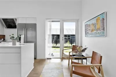 a kitchen and dining room with a table and chairs at BL698-Blokhus-Kr-Thomsensvej-3 in Blokhus