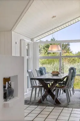 a dining room with a table and some chairs at BL1243-Saltum-Kvansletten-22 in Saltum