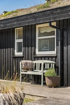 a white chair sitting on a deck in front of a house at BL1243-Saltum-Kvansletten-22 in Saltum
