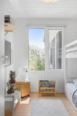 a room with a bed and a window in a bedroom at BL1668-Blokhus-Skraavejen-4 in Blokhus
