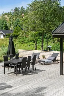 a table and chairs on a wooden deck at BL1668-Blokhus-Skraavejen-4 in Blokhus