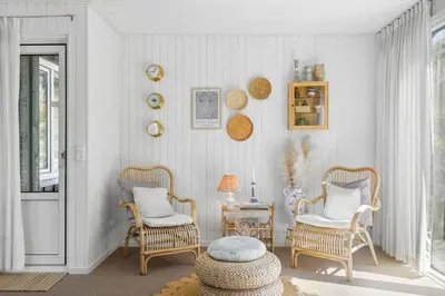 a living room with two chairs and a table at BL1668-Blokhus-Skraavejen-4 in Blokhus