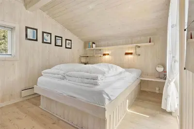 a bedroom with a white bed in a room at BL164-Saltum-Lyngsletten-7 in Saltum