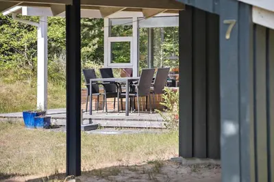 a patio with a table and chairs on a house at BL164-Saltum-Lyngsletten-7 in Saltum