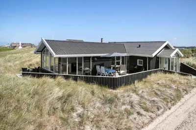 a house on top of a sand hill at BL1483-Blokhus-Ved-Skoven-25 in Blokhus