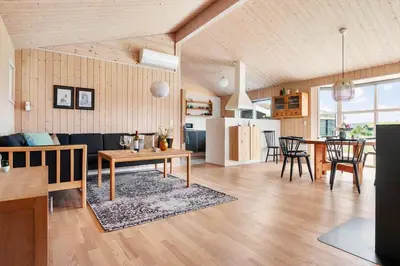 a living room and kitchen with a table and chairs at BL1399-Saltum-Laustvej-30 in Saltum