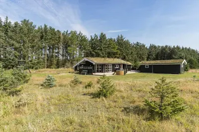 a cabin in the middle of a field with trees at BL1399-Saltum-Laustvej-30 in Saltum
