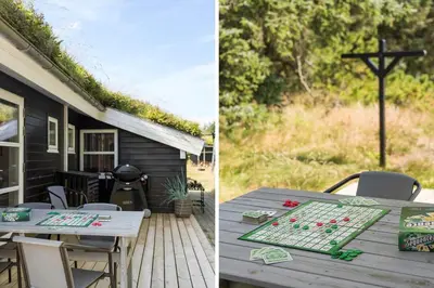 a picnic table on a deck next to a house at BL1399-Saltum-Laustvej-30 in Saltum