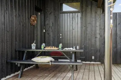 a wooden room with a table with a chessboard on it at BL200-Saltum-Laustvej-9 in Saltum