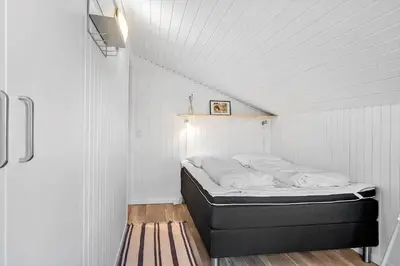 a bedroom with a bed in a white room at BL1486-Saltum-Ornebjergvej-4 in Saltum